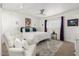 Spacious primary bedroom featuring large plush chair, complemented by a ceiling fan and lots of light at 2843 E Captain Dreyfus Ave, Phoenix, AZ 85032