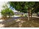 Secluded backyard garden with mature trees, stepping stones and landscaping at 3229 E Mountain Village Cir, Phoenix, AZ 85042
