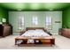 Bright bedroom with green walls, three windows, and neutral carpet at 3229 E Mountain Village Cir, Phoenix, AZ 85042