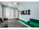 Bedroom featuring light blue walls, a ceiling fan, a wall-mounted television, and play space for children at 3229 E Mountain Village Cir, Phoenix, AZ 85042