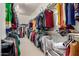 Spacious walk-in closet offering abundant storage with rows of hanging clothes and shelves for personal items at 3229 E Mountain Village Cir, Phoenix, AZ 85042