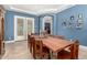 Stylish dining room with a large wooden table, chairs, and blue walls at 3229 E Mountain Village Cir, Phoenix, AZ 85042