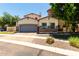 Beautiful home with neutral stucco, stone accents, two car garage, and mature landscaping at 3229 E Mountain Village Cir, Phoenix, AZ 85042