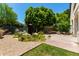 Manicured backyard landscape featuring a fountain, rocks, cacti, desert plants, and a gravel ground cover at 3229 E Mountain Village Cir, Phoenix, AZ 85042