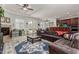 Spacious living room with fireplace, sectional sofa, and open floor plan at 3229 E Mountain Village Cir, Phoenix, AZ 85042