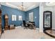 Office space with blue walls, desk, chandelier, and iron accented doorway at 3229 E Mountain Village Cir, Phoenix, AZ 85042