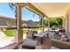 Covered patio with comfortable seating and view of landscaped backyard, perfect for outdoor entertaining at 3229 E Mountain Village Cir, Phoenix, AZ 85042