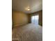 Bedroom features neutral carpeting and a sliding door at 3434 E Baseline Rd # 204, Phoenix, AZ 85042