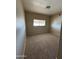 The bedroom has neutral carpeting and a window with blinds at 3434 E Baseline Rd # 204, Phoenix, AZ 85042