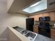 The kitchen has granite countertops and black appliances at 3434 E Baseline Rd # 204, Phoenix, AZ 85042
