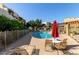 Community pool with lounge chairs and tables surrounded by well-maintained landscaping and multi-story buildings at 3434 E Baseline Rd # 204, Phoenix, AZ 85042