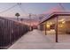 Backyard carport featuring wood beams and concrete flooring, offering shaded parking and outdoor activity space at 3513 W Maryland Ave, Phoenix, AZ 85019
