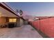 Backyard carport with wood beams, concrete flooring, and outdoor activity space perfect for secure vehicle parking at 3513 W Maryland Ave, Phoenix, AZ 85019