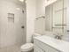 This bathroom features tiled shower, a modern sink and vanity, and tiled floors at 3513 W Maryland Ave, Phoenix, AZ 85019