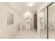 Bright bathroom featuring tiled floors, vanity, shower, toilet, and a large sliding door closet at 3513 W Maryland Ave, Phoenix, AZ 85019