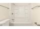 Bright bathroom featuring a white shower-tub combo and matching fixtures at 3513 W Maryland Ave, Phoenix, AZ 85019