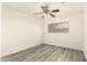 Empty bedroom boasts modern vinyl floors, ceiling fan, and a window at 3513 W Maryland Ave, Phoenix, AZ 85019