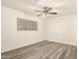 This bedroom boasts wood-look floors and a ceiling fan for added comfort at 3513 W Maryland Ave, Phoenix, AZ 85019