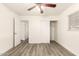 This bedroom features wood-look floors, a closet, and a ceiling fan for added comfort at 3513 W Maryland Ave, Phoenix, AZ 85019