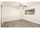 Empty bedroom boasting modern vinyl floors, ceiling fan, closet, and a window at 3513 W Maryland Ave, Phoenix, AZ 85019