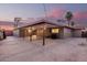 Covered carport with wood support beams and concrete flooring, providing shelter and an ideal outdoor space for projects at 3513 W Maryland Ave, Phoenix, AZ 85019