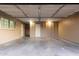 This garage features an automatic door, painted walls, and ample parking space at 3513 W Maryland Ave, Phoenix, AZ 85019