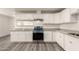 Well-equipped kitchen featuring stainless steel appliances, granite countertops and sleek white cabinetry at 3513 W Maryland Ave, Phoenix, AZ 85019
