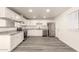 Modern kitchen featuring white cabinets, granite countertops, stainless steel appliances and hard surface floors at 3513 W Maryland Ave, Phoenix, AZ 85019