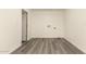 The laundry room features neutral colors, wood-look floors, and washer and dryer hookups at 3513 W Maryland Ave, Phoenix, AZ 85019