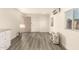 Spacious living room features new gray vinyl floors and a mini-split air conditioning unit at 3513 W Maryland Ave, Phoenix, AZ 85019