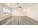 Bright and airy living room features stylish gray flooring, neutral walls, and a contemporary ceiling fan at 3513 W Maryland Ave, Phoenix, AZ 85019