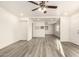 Spacious and well-lit living room featuring hard surface floors, a ceiling fan, and fresh white paint at 3513 W Maryland Ave, Phoenix, AZ 85019