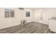 Living room with vinyl floors and mini-split air conditioning unit at 3513 W Maryland Ave, Phoenix, AZ 85019