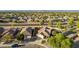 Aerial view of a well-maintained single-Gathering home with desert landscaping, nestled in a vibrant, green neighborhood at 3532 W Mesquite Ave, San Tan Valley, AZ 85144