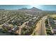 Expansive aerial view showcases desert community, tile roof homes, and manicured landscaping, with mountain views at 3532 W Mesquite Ave, San Tan Valley, AZ 85144