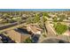 Aerial view of a well-maintained single-Gathering home with desert landscaping, nestled in a vibrant, green neighborhood at 3532 W Mesquite Ave, San Tan Valley, AZ 85144