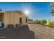 View of the backyard showing the desert landscape and the back of the house at 3532 W Mesquite Ave, San Tan Valley, AZ 85144