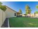 Inviting backyard with covered patio, lush lawn, outdoor seating, and pool access at 3532 W Mesquite Ave, San Tan Valley, AZ 85144