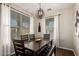 Cozy dining room featuring a dark wooden table, bench seating, and decorative lighting at 3532 W Mesquite Ave, San Tan Valley, AZ 85144