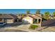Home with a two-car garage, lawn, and desert landscaping at 3532 W Mesquite Ave, San Tan Valley, AZ 85144