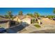Home with a two-car garage, lawn, and desert landscaping at 3532 W Mesquite Ave, San Tan Valley, AZ 85144