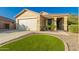 Attractive home with a well-manicured front yard and a two-car garage at 3532 W Mesquite Ave, San Tan Valley, AZ 85144