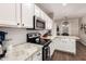Modern kitchen featuring white cabinetry, granite counters, and stainless steel appliances at 3532 W Mesquite Ave, San Tan Valley, AZ 85144