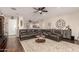 Comfortable living room featuring a ceiling fan, large leather sectional sofa, and neutral paint at 3532 W Mesquite Ave, San Tan Valley, AZ 85144