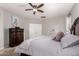 Comfortable main bedroom featuring neutral walls, dark wood furniture, and a ceiling fan at 3532 W Mesquite Ave, San Tan Valley, AZ 85144
