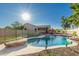 Exterior view of backyard pool with privacy fence and desert landscaping at 3532 W Mesquite Ave, San Tan Valley, AZ 85144