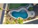 Aerial view of a backyard pool with desert landscaping and a small table at 3532 W Mesquite Ave, San Tan Valley, AZ 85144