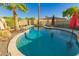 Backyard swimming pool featuring desert landscaping, rock accents, and pool safety fence at 3532 W Mesquite Ave, San Tan Valley, AZ 85144