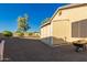 Tan backyard shed with double doors for storage, located in a gravel backyard at 3532 W Mesquite Ave, San Tan Valley, AZ 85144