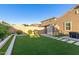 This landscaped backyard features artificial turf, a grill, and storage shed at 4152 W Bradshaw Creek Ln, New River, AZ 85087